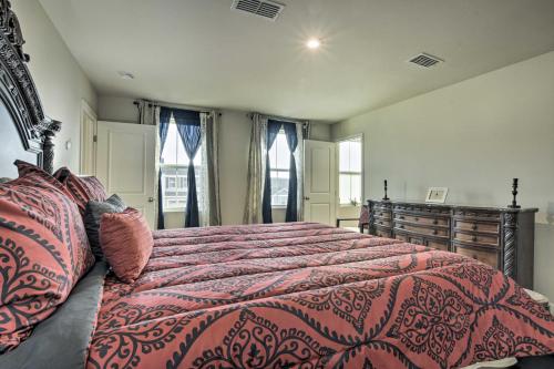 a bedroom with a large bed with a red comforter at Cozy Durham Home - 9 Mi to Duke University! in Durham