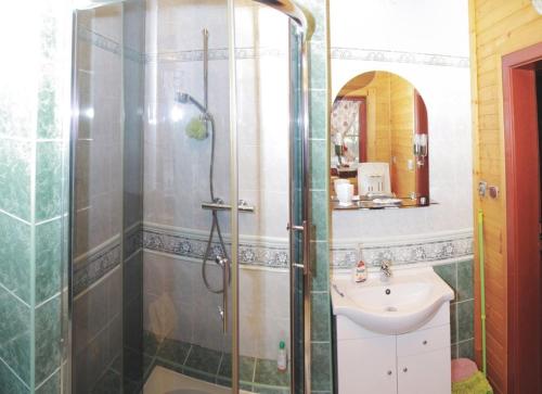 a bathroom with a shower and a sink at Rozprávkový zrub in Dúbrava