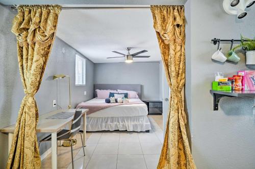 a bedroom with a bed and a desk and curtains at North Las Vegas Studio with Fire Pit 10 Mi to Strip in Las Vegas