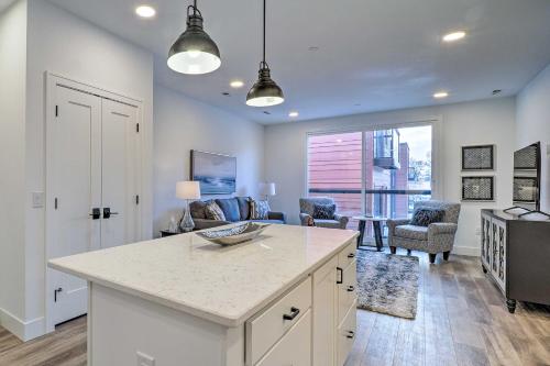 a kitchen with a counter and a living room at Winter Escape! Downtown Traverse City Condo in Traverse City