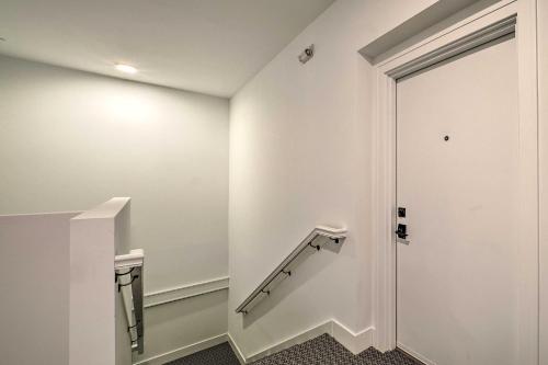 a staircase in a building with a white wall at Downtown Traverse City Condo Less Than half Mi to Beach! in Traverse City