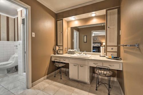 a bathroom with a sink and a mirror at Spacious Memphis Home - Walk to Graceland in Memphis
