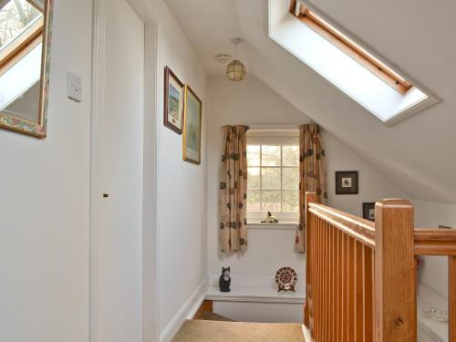a staircase in a house with skylights at Edenwoodend Cottage in Kilmaron