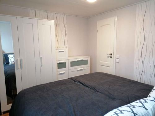 a bedroom with a bed and a dresser at Ferienhaus Glücksmomente in Möhnesee