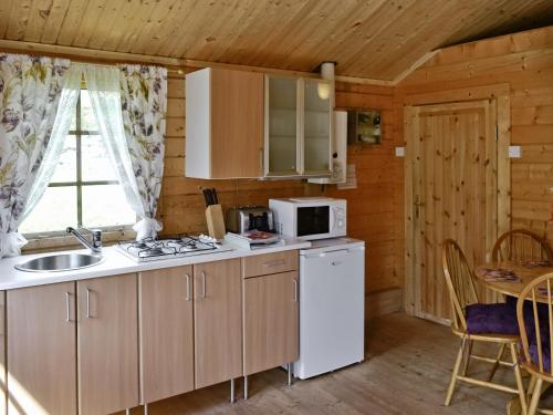 a kitchen with a sink and a stove top oven at Fairoaks in Felindre