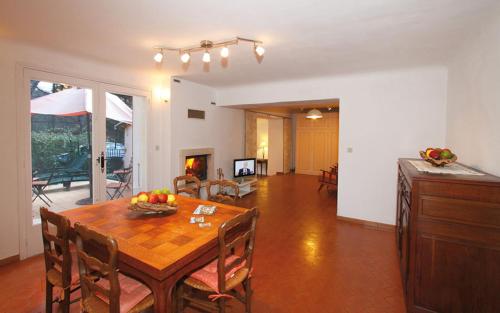 a living room with a wooden table and a dining room at La bayorre in Hyères