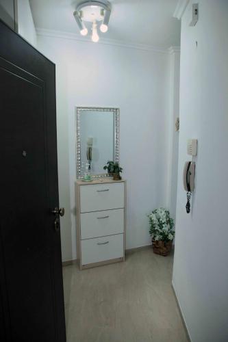a hallway with a dresser with a mirror and a phone at Hellas Dream in Perea