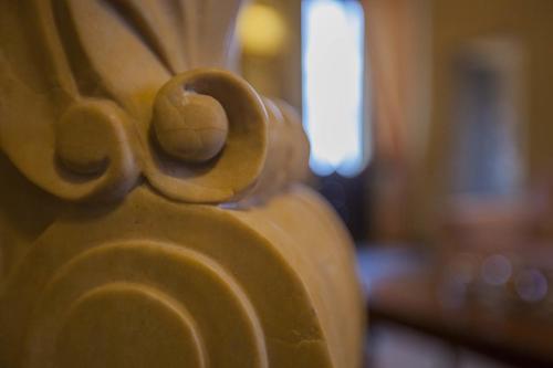 a close up of a carved wooden object in a church at Palazzo Carletti in Montepulciano
