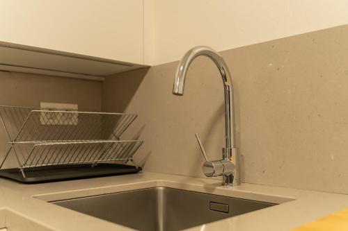 - un évier de cuisine avec un robinet sur un comptoir dans l'établissement Orzan Beach by Urban Flats, à La Corogne
