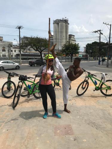 a man doing a handstand on a pole with a woman at TURISHOUSE SUITES in Salvador