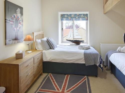 Voodi või voodid majutusasutuse Scarborough Cottage toas