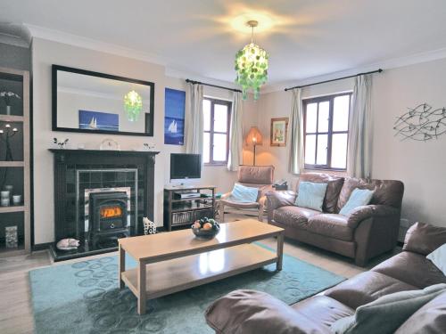 a living room with a couch and a coffee table at Pebble Cottage - Hw7447 in Broad Haven