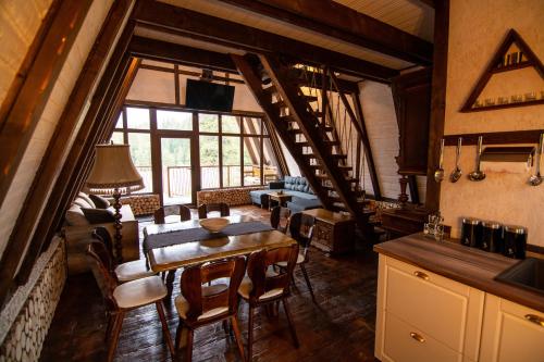 a kitchen and dining room with a table and chairs at Camere de închiriat Pași Liberi in Tău Bistra
