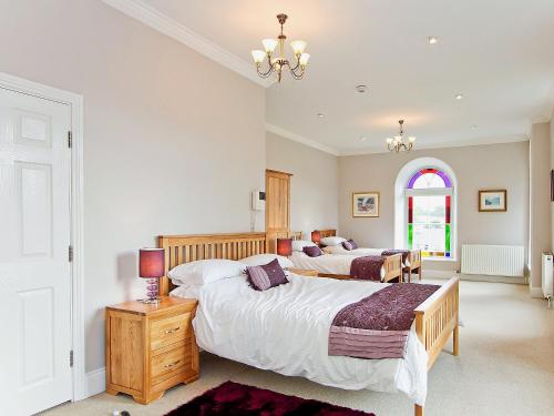 a bedroom with two beds and a window at Dales Chapel in Middleton in Teesdale
