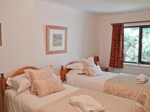 a bedroom with two beds and a window at Long Mynd in Ambleside