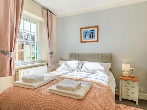 a bedroom with a bed with two towels on it at Dunster Castle Hill View - Uk13179 in Dunster