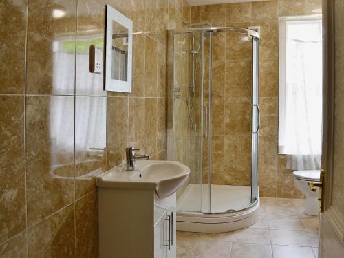 a bathroom with a shower and a sink at Maes Gwyn - Hw7644 in Llandudno