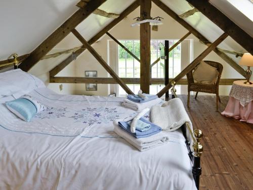 a bedroom with a white bed in a attic at Shrubberies Cottage - Dc5472 in Skinningrove