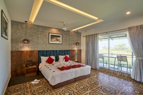 a bedroom with a bed with red flowers on it at Haze and Kites Resort Munnar in Munnar