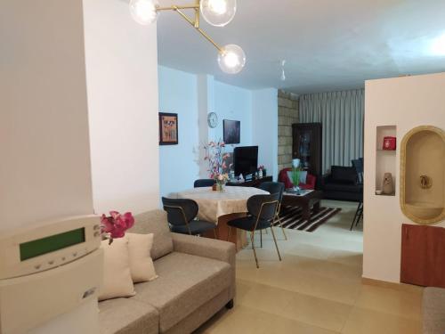 a living room with a couch and a table at Enjoy home in Jerusalem