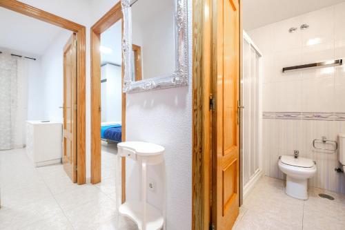 a bathroom with a toilet and a sink in it at Benidorm Old Town House - Casa Casco Antiguo in Benidorm