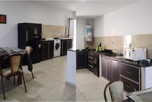 a kitchen with black cabinets and a table with a microwave at Consorcio España 216 in San Juan