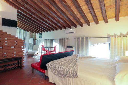 a bedroom with a bed and a red chair at Villa D&D in Parma