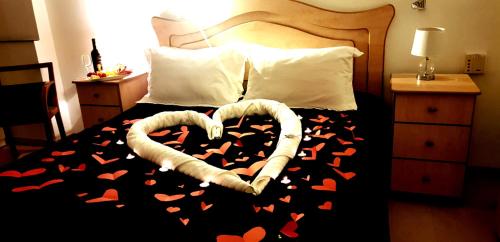 a bed with a heart made out of hearts on it at Enjoy home in Jerusalem