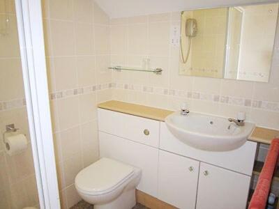 a white bathroom with a toilet and a sink at Valley View- Hms in Combe Martin
