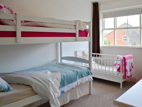 a bedroom with two bunk beds and a window at Hanson Avenue in Honington