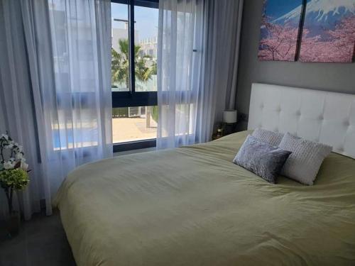 ein Schlafzimmer mit einem großen Bett und einem großen Fenster in der Unterkunft Casa LeLa met dakterras in Pilar de la Horadada