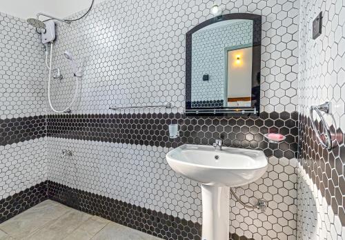 a bathroom with a sink and a mirror at Blueray Villa in Unawatuna