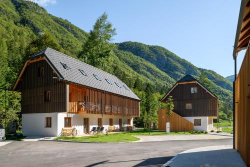 een paar gebouwen met bergen op de achtergrond bij Residence Soča in Soča