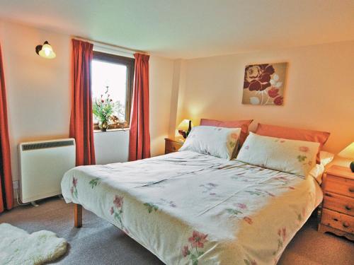 a bedroom with a large bed and a window at The Granary - Hw7187 in Henrys Moat