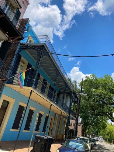 a blue and white building with a flag on a street at Jean Lafitte House in New Orleans
