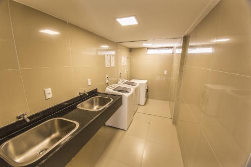 a bathroom with a sink and a stove and a toilet at GOLDFLAT Cabo Branco by PenareiaTurBr in João Pessoa