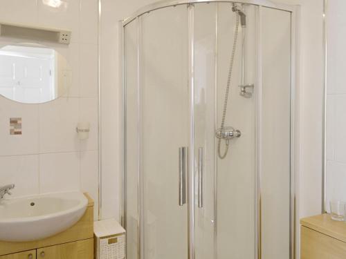 a bathroom with a shower and a sink at Bramley Cottage in Brean