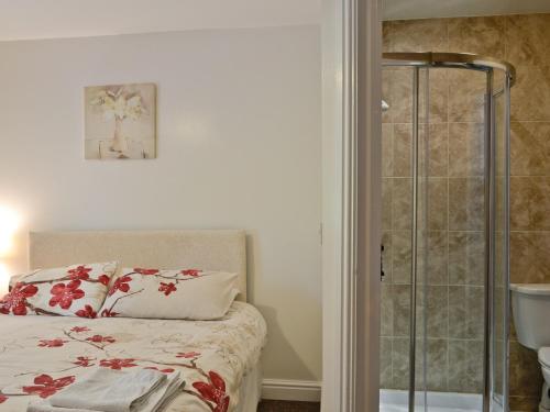 a bedroom with a bed and a glass shower at Mole in Swimbridge