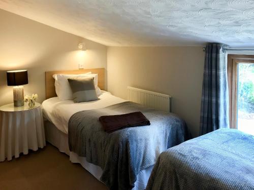 a hotel room with a bed and a window at Stiff Key Barn 30955 in Thursford