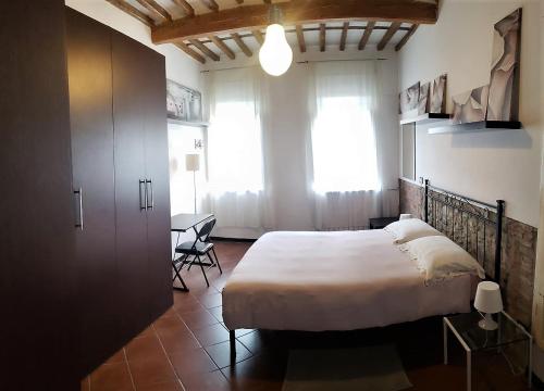 Posteľ alebo postele v izbe v ubytovaní Appartamento La Torretta