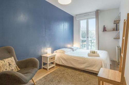 um quarto azul com uma cama e uma cadeira em Cosy flat in Monplaisir district in Lyon - Welkeys em Lyon