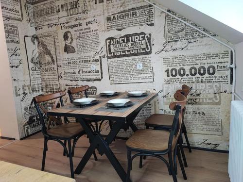 a table and chairs in front of a wall with newspapers at Blackwood Hill in Belgrade