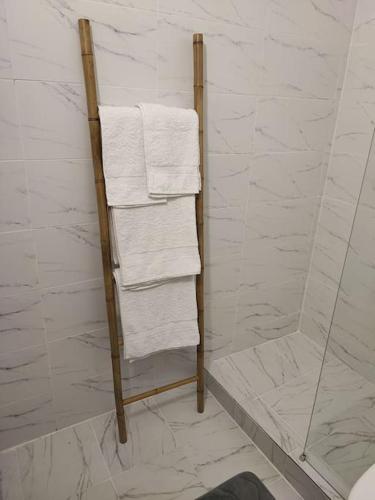 a towel rack in a bathroom with white towels at Blackwood Hill in Belgrade