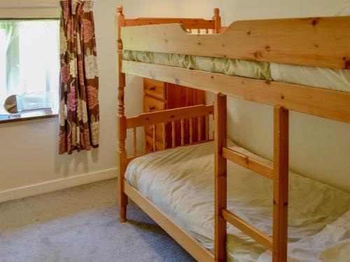 two bunk beds in a room with a window at The Wherry Arch in Neatishead