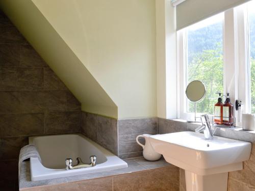 a bathroom with a tub and a sink and a window at The Ranch in Benmore