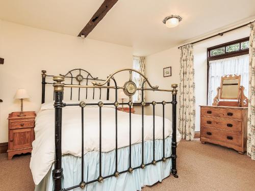 a bedroom with a bed and a dresser and a window at South Court Apt - FHP in Combe Martin