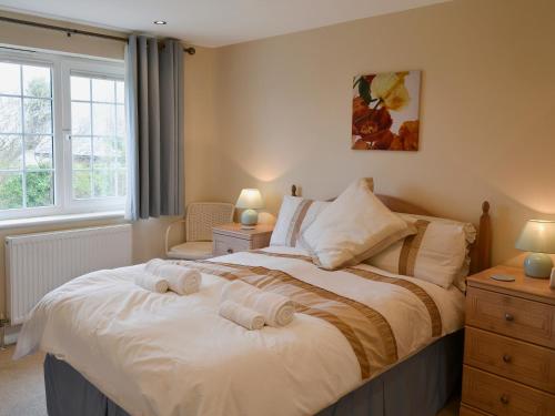 a bedroom with a bed with two towels on it at The Old Butchers in Crantock