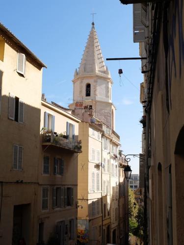 a tall building with a steeple on a street at VIEUX PORT in Marseille