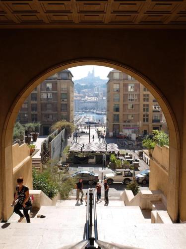 an archway with a group of people in a city at VIEUX PORT in Marseille
