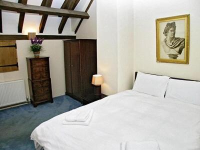 a bedroom with a large white bed in a room at Thornsdale Oast House in Stone